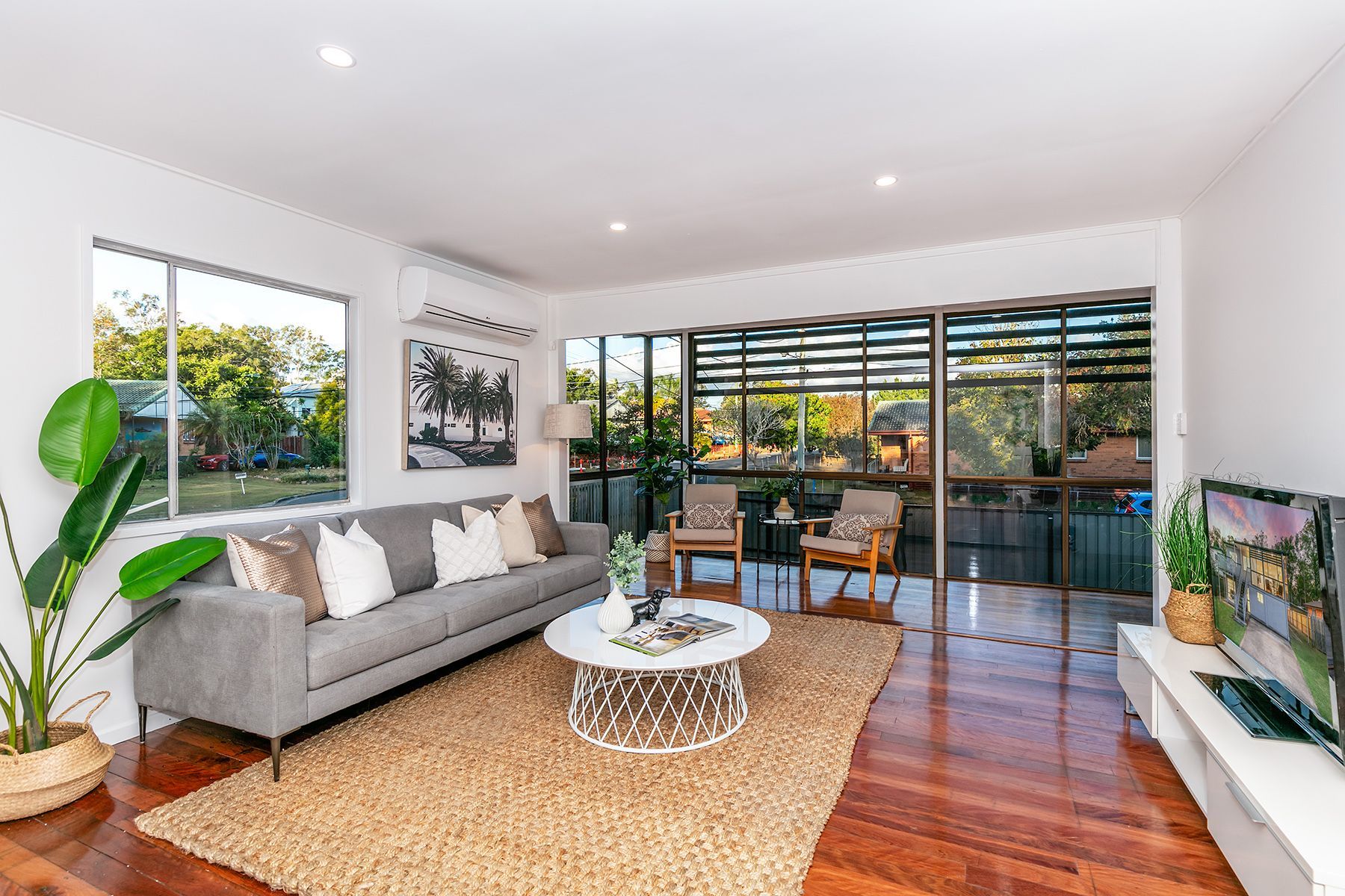 Open-plan upstairs living with timber floors, Woodridge renovation